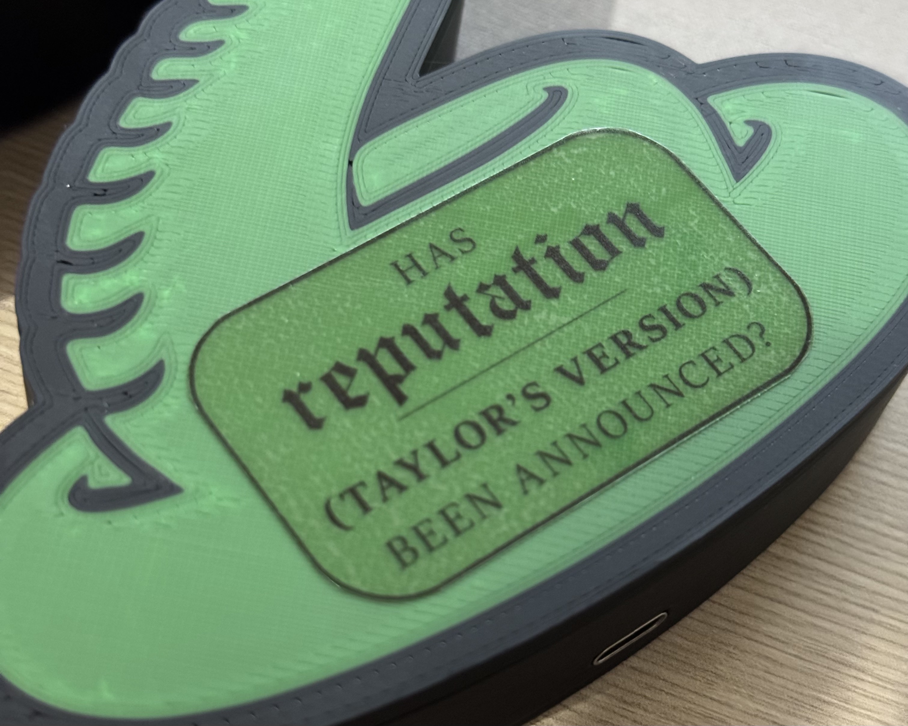 A close-up view of the Reputation alarm, with a black sticker reading "Has Reputation (Taylor's Version) been announced?"